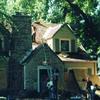 Another picture of a house being protected by plywood during roof removal.